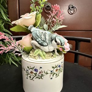 bluejay-bird-floral-wildflower-decorative-mug Bluebird figurine sitting among faux blush roses and greenery atop a vintage floral ceramic jar.
