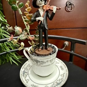 skeleton-violinist-mariachi-holiday-teacup Day of the Dead-style skeleton in a sombrero playing the violin, standing in faux gravel and greenery in a vintage teacup.